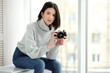 © azhurfoto - girl with a camera sitting by the window
