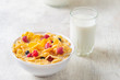 Tasty corn flakes with raspberries and blueberries on white background.Breakfast. Cornflakes with berry and milk. Cereal flakes. Fresh healthy food. Morning meal. Wooden table. Organic. Diet concept.