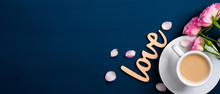 Valentine Day Banner. Roses Bouquet, Coffee Cup, Petals, Wooden Text Sign "Love"on Blue Background. Flat Lay, Top View. Love And Romance Concept.