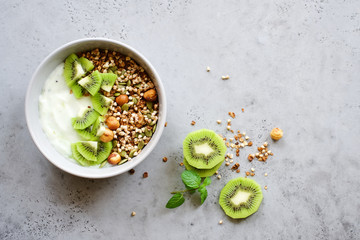 Wall Mural - Buckwheat granola with yogurt and kiwi. Nutritious healthy breakfast