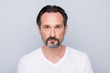 © deagreez - Closeup photo of handsome aged man seriously looking mirror without smile dislike mature wrinkles appearance wear white t-shirt isolated grey color background