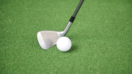 Wall Mural - Image of golf iron and golf ball on green grass