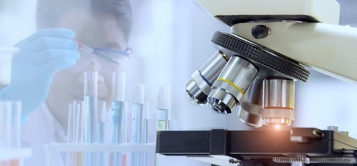 Wall Mural - laboratory concept: close up of microscope with blurred background of the scientist is researching i