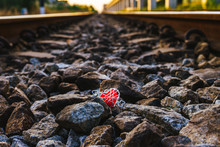 A Red Heart On A Stone Pile In A Train Track