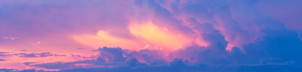 Wall Mural - Fantasy colorful background, Gold sunlight on blue sky and moving purple cloud before sunset