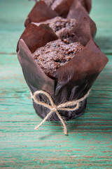 Closeup of fresh tasty baked chocolate muffins on a wooden table for the holiday