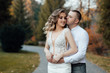 © Tetiana Moish - Loving couple in stylish wear hugs in the park in the autumn season. Autumn. Golden autumn. Golden leaves. Portrait of happy young couple outdoor
