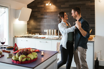 Couple in love dancing in the new house - Millennials have fun together in the apartment