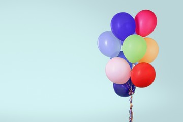 Bunch of colorful balloons on pastel background