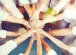 © BillionPhotos.com - People putting their hands together,  teamwork concept