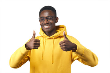 Wall Mural - young black man in yellow hoodie in glasses shows likes