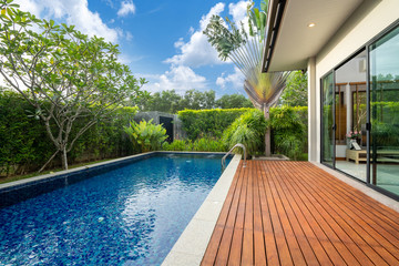 swimming pool and decking in garden of luxury home