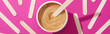 top view of depilation wax in container with sticks on pink background, panoramic shot