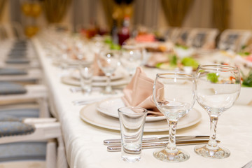 a long white table set with dishes