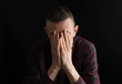 © Oleksandr - Depressed man on a black background. The concept of fatigue, grief, problems.