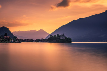 Wall Mural - Sunset above Iseltwald peninsula and former castle in Switzerland