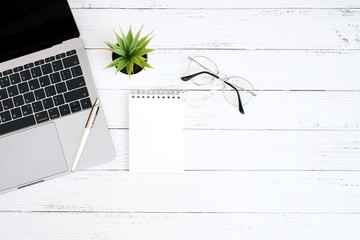 Wall Mural - Top view business office concept on vintage wooden table desk with blank notepad and supplies, flat lay with copy space, work space