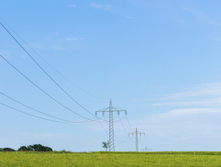 Wall Mural - electricity pylons in field