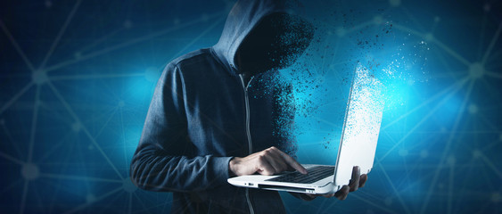 Hacker with laptop. Computer crime.