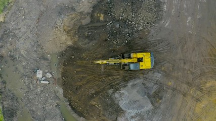 Wall Mural - Excavator tractors on caterpillars in the foundation pit during the construction of the building foundation, digging. Aerial top view