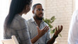 © fizkes - Head shot young african american male psychologist meeting patients.