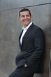 © Fernando - Handsome Latino executive man leaving office, talking on the phone and wearing casimir suit