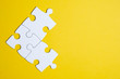 © gesrey - Three pieces of a puzzle united among themselves on a yellow background. Teamwork concept.