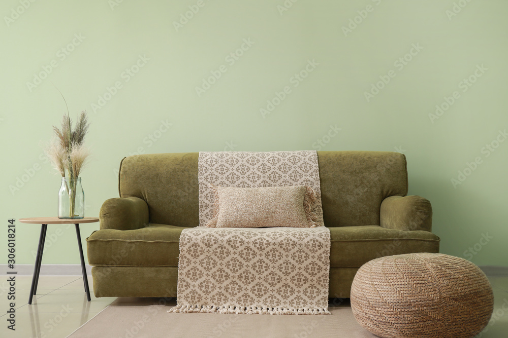 Stylish interior of room with cozy sofa and table