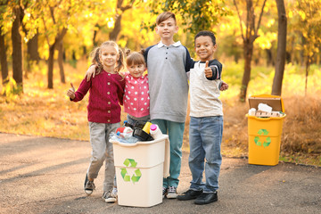 Wall Mural - Little children collecting trash outdoors. Concept of recycling