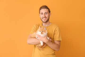 Man with cute cat on color background