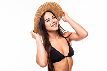 Wall Mural - Beauty in hat. Attractive young woman in bikini looking at camera and adjusting her hat while standing isolated on white