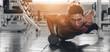 © Mongkolchon - caucasian man having workout for bodybuilding by pushing up with holding dumbbells in one hand in fitness center