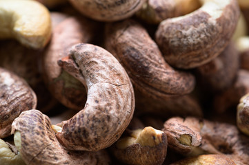 Roasted cashews on natural wooden table background