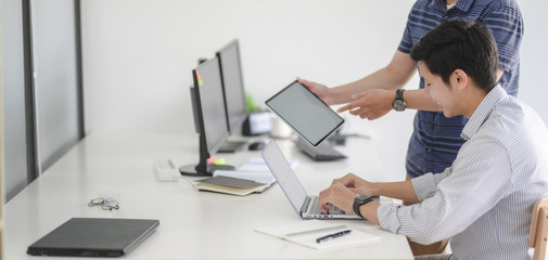 Cropped shot of professional UI web developer team working on their project together in modern workplace