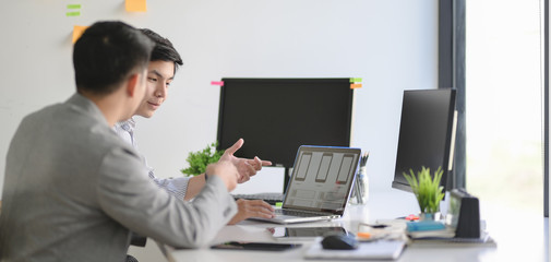 Group of professional UX graphic designer working on smartphone template together in modern office