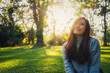 © Farknot Architect - Portrait image of a beautiful asian woman sitting among nature in the park before sunset
