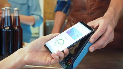 Young Woman is Using Contactless NFC Payment App Installed on Her Smartphone to Pay for Gourmet Street Food