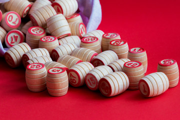 Barrels of wooden Lotto randomly spilled out of the bag for a fun game, close-up.