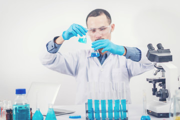 scientist with equipment and science experiments ,laboratory glassware containing chemical liquid for design or decorate science or other your content and selective focus