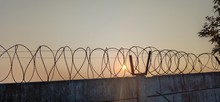 Barbed Wire On Background Of Blue Sky