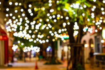 Blur - bokeh - Decorative outdoor string lights hanging on tree in the garden at night time - decorative christmas lights - happy new year