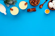 © 9dreamstudio - Ingredients for New Year drink eggnog - eggs, milk, cinnamon on blue background top view frame copy space