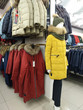 Sale of warm female winter coats and a mannequin dressed in winter outwear in the shop