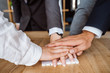 © teksomolika - United hands of business team on workspace background