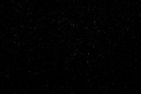Fototapeta Miasto - WHITE BOKEH ON A BLACK BACKGROUND. LIGHT SPOTS TEXTURE. FALLING SNOW. STAR SKY.