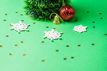 Christmas decoration on the green background. Ornaments, snowflakes, stars. Christmas tree.