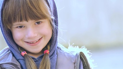 Wall Mural - Portrait of happy child girl in warm clothes in autumn outdoors.