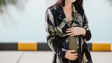 Elegant style of a pregnant woman in a modern city. Fashion trends for pregnant women