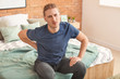 © Pixel-Shot - Young man suffering from back pain at home