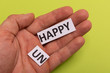 © Andrzej Wilusz - man hand holding card with text unhappy, cutting word 'un' so it written 'happy'. Copy space. Lime background. Studio shoot